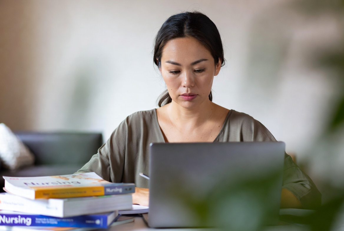 Adult student studying nursing materials for an accelerated BSN program.