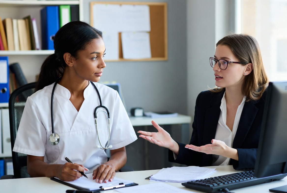 Nurse discussing how to choose the right LPN-to-RN program with an advisor.
