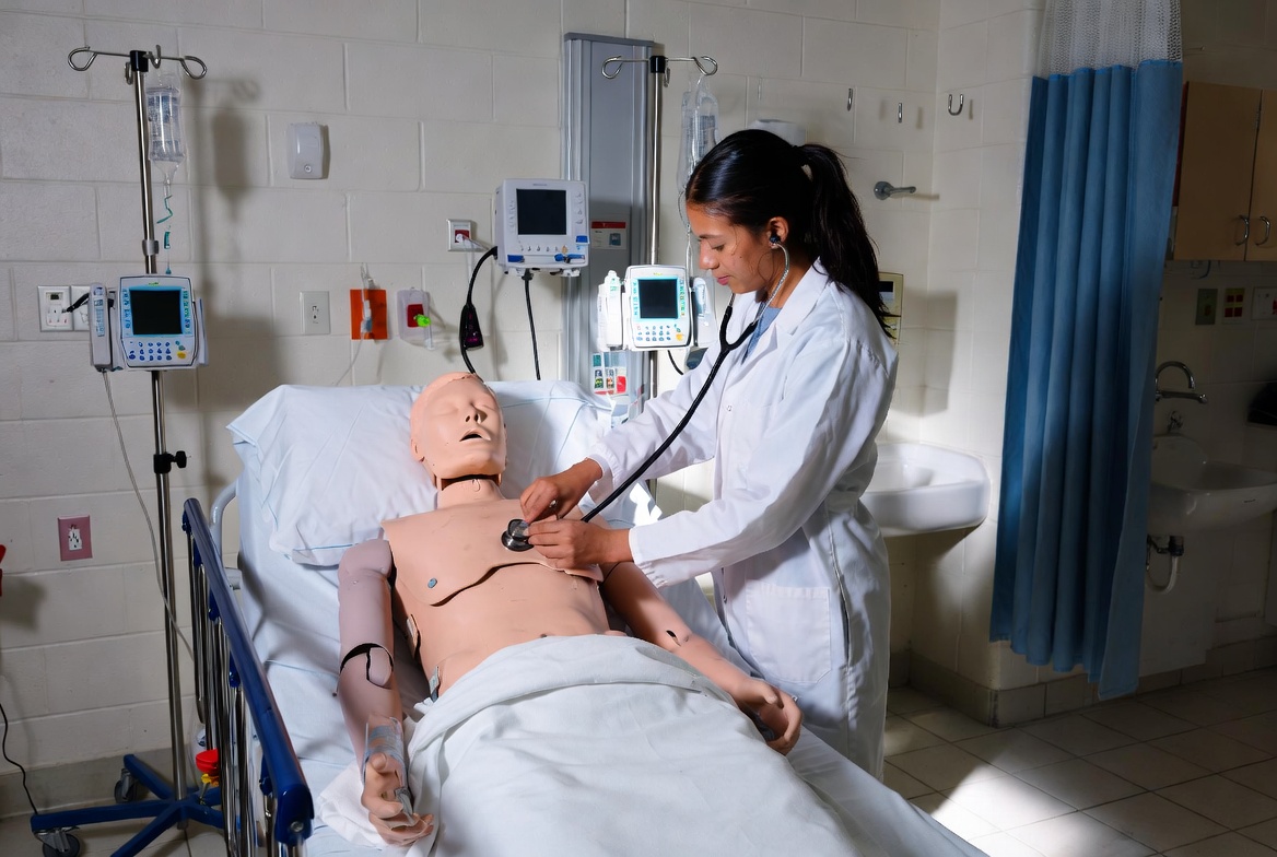 Nursing student practicing in a clinical simulation lab in Arizona’s ABSN program.
