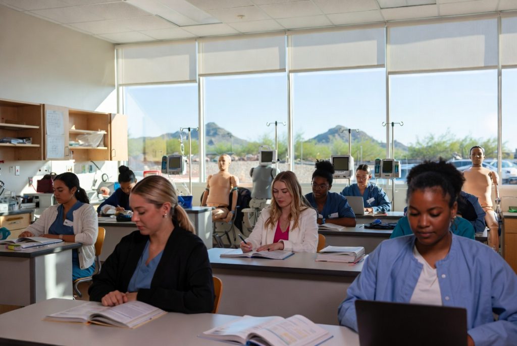 Arizona nursing students working in a simulation lab representing nursing school costs and financial aid.