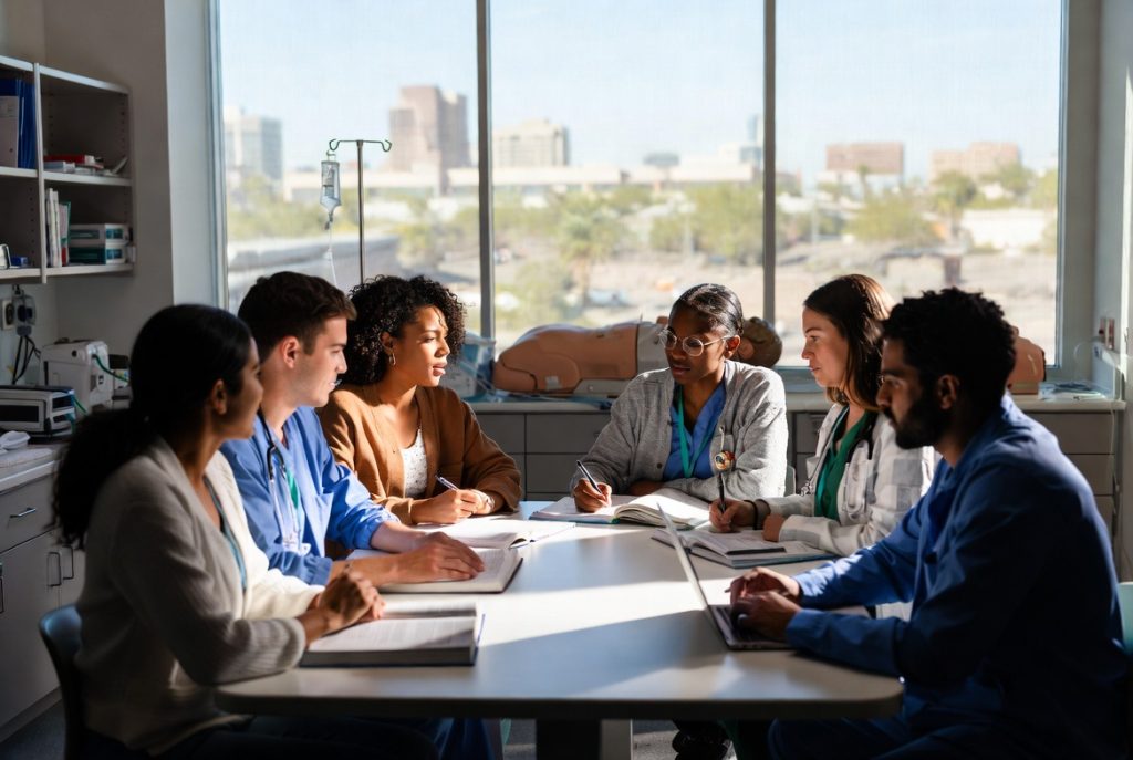 Photo of Arizona nursing students practicing in a simulation lab for a BSN vs. ADN comparison.