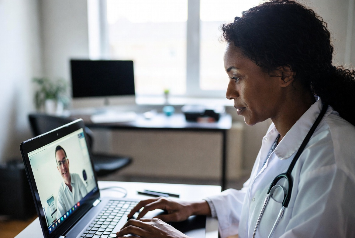 Nurse participating in an online MSN class through a video call from home.