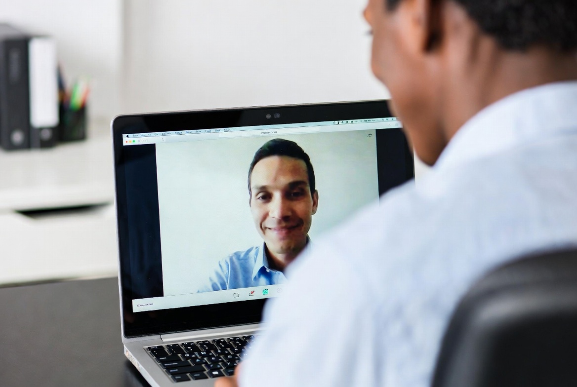 Academic advisor on a video call answering questions about online nursing programs.